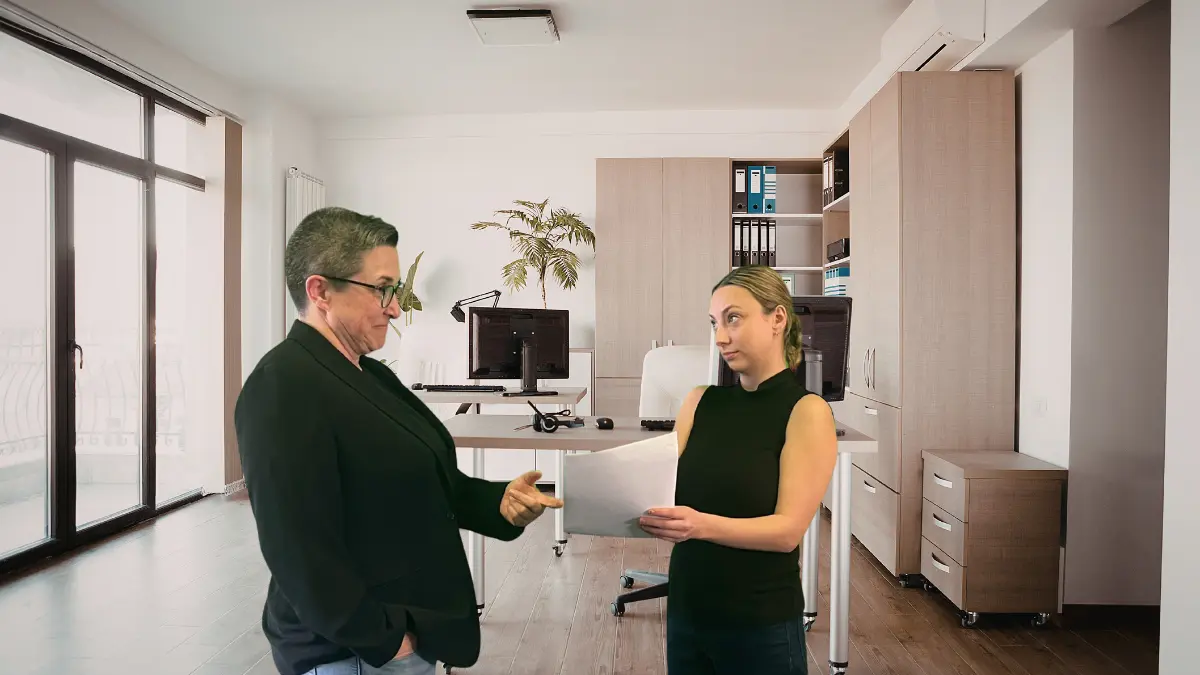 Employee reviewing arbitration agreement while employer gestures for them to sign in a California workplace